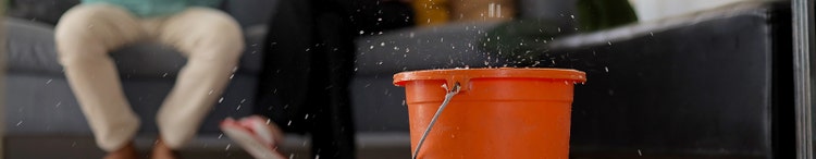 man calling emergency roof leaking damage