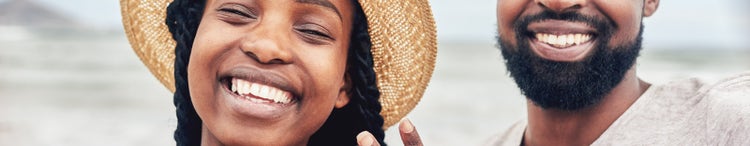 couple smiling with engagement ring