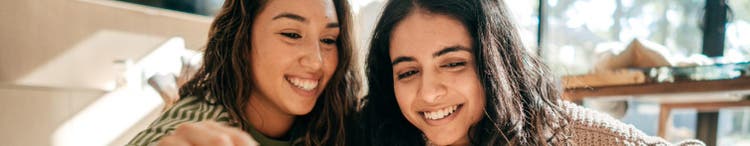 Two women looking at wooden toy cars