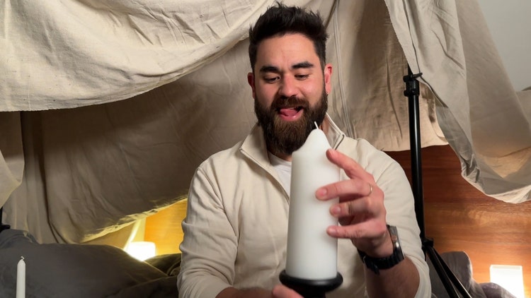 Man sitting and holding a candle