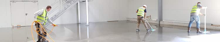 workers cleaning concrete floor