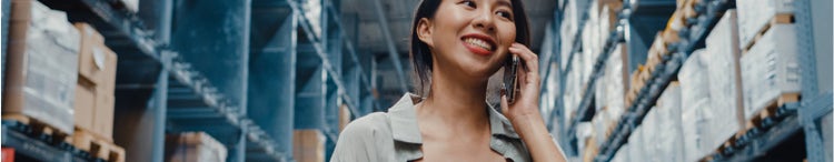 Businesswoman on the phone at a warehouse