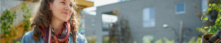 smiling woman at outdoor vegetable stall