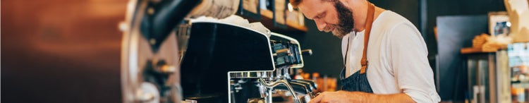 male barista making cappuccino