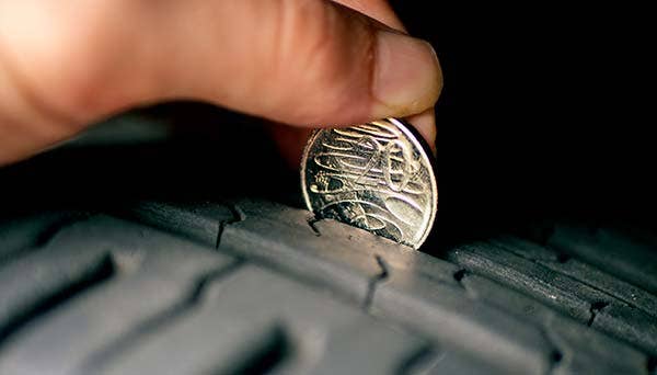 Testing tyre tread depth with a coin