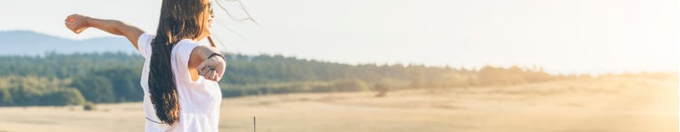 smiling woman standing next to beach