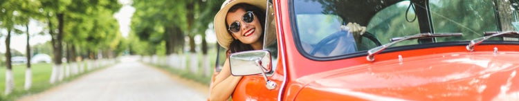 woman driving vintage car in the countryside