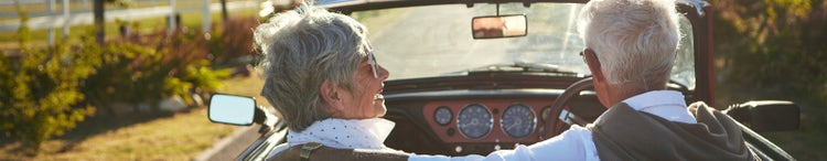 woman and man driving convertible