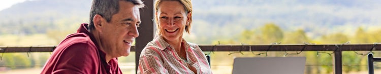 couple using a computer on porch