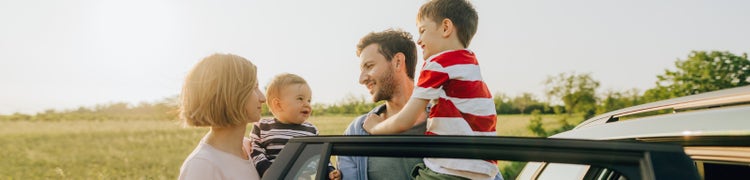 young family by a car