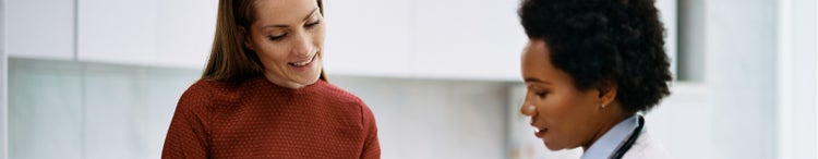 happy woman talking to female doctor