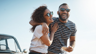 Couple laughing wearing sunglasses