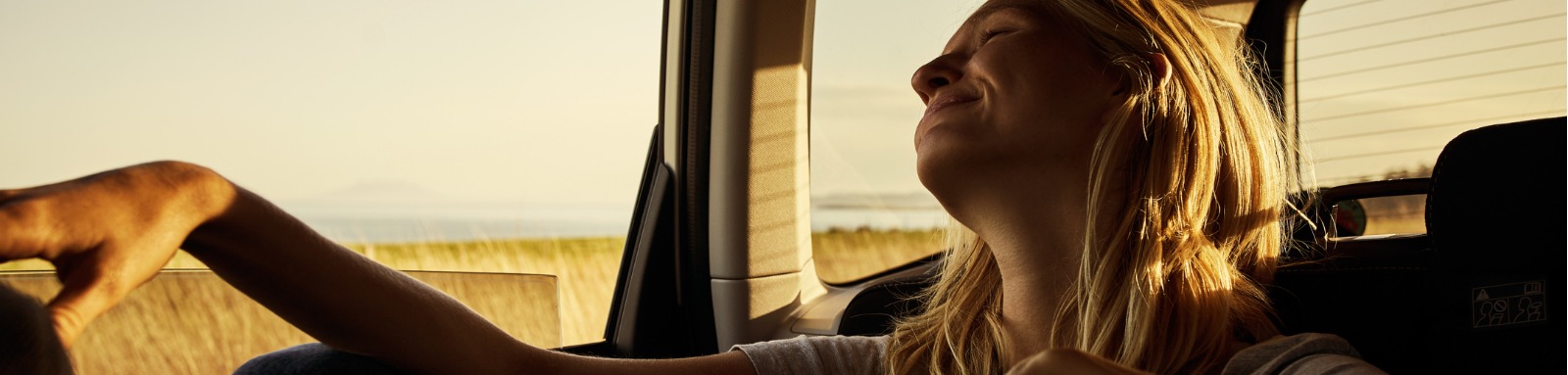 Blonde woman smiling in car 