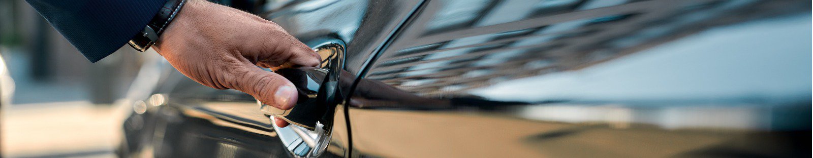 Close up of hand holding car door handle