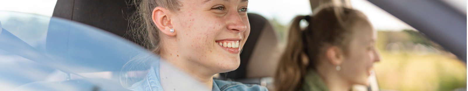 Female driver and friend in car