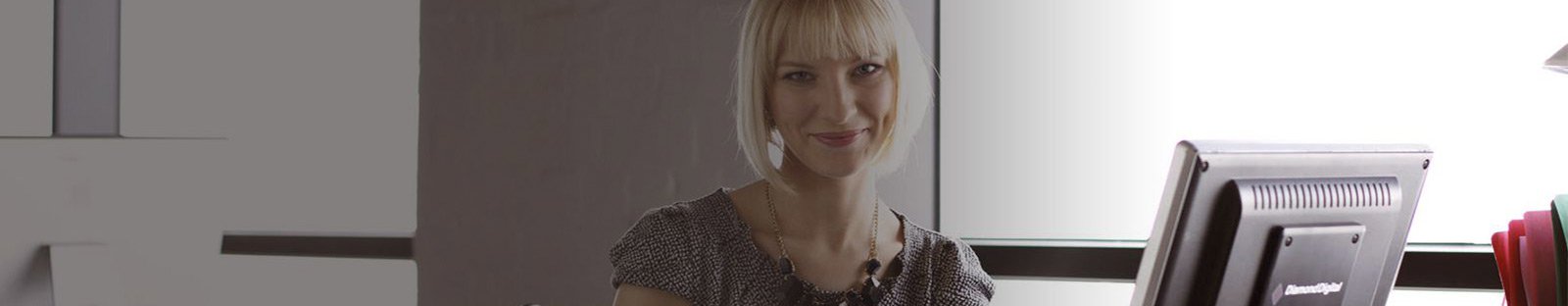 Woman smiling sitting at a desk