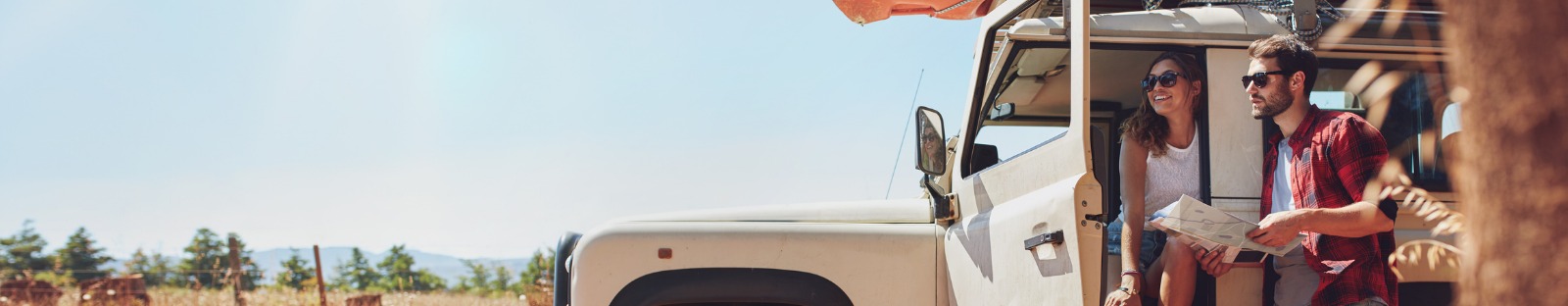 man and woman by parked car rural australia