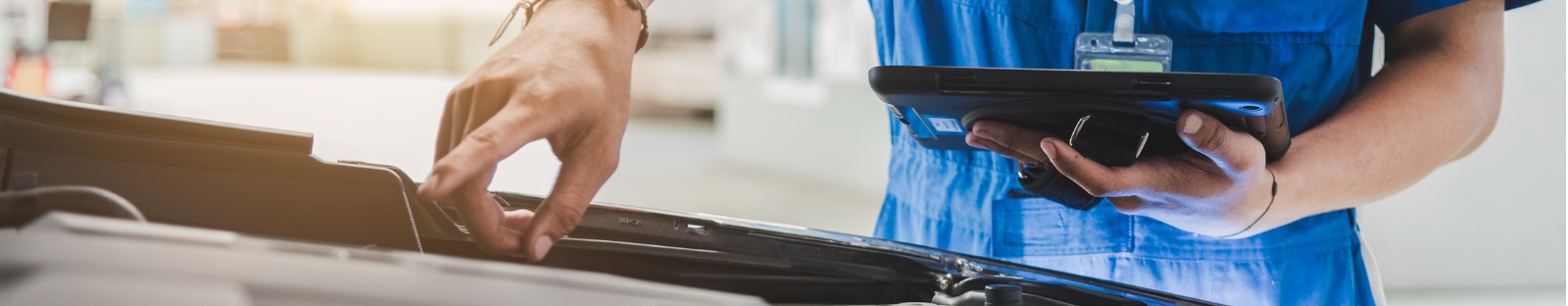 Mechanic working on a vehicle for its roadworthy certificate