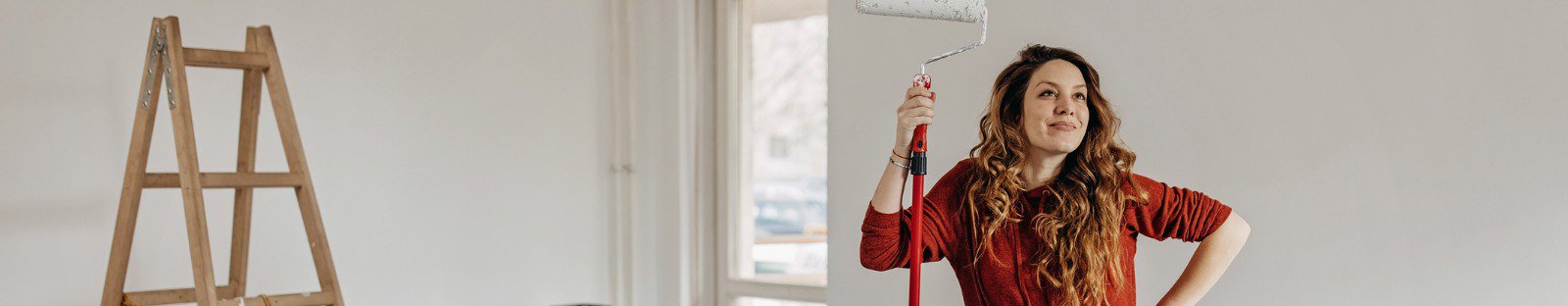 pregnant woman painting nursery