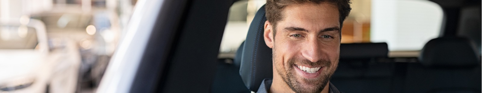 Smiling man driving car