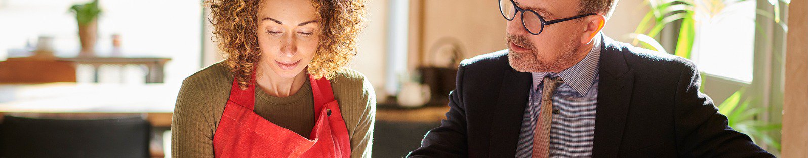 Woman and man sitting at table with open folder