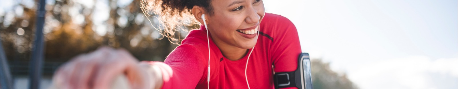 Woman stretching outdoors with earphones