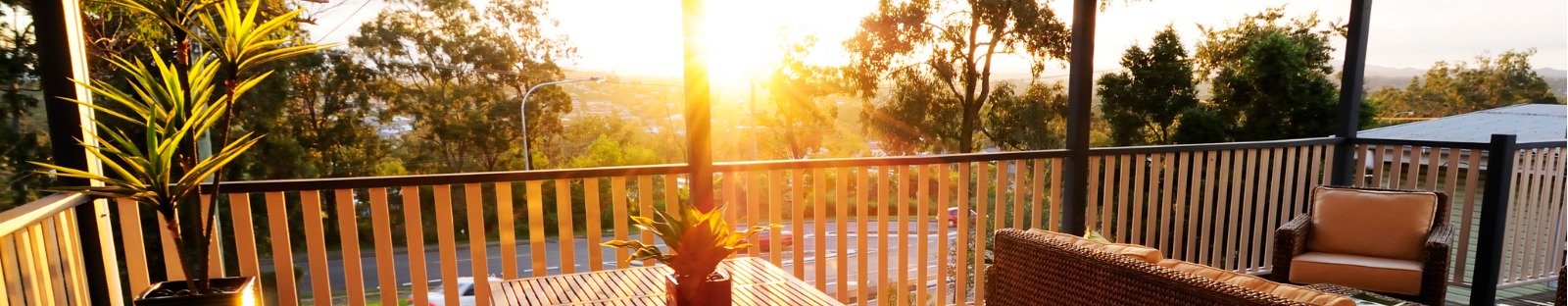 Wooden veranda overlooking bush at sunset