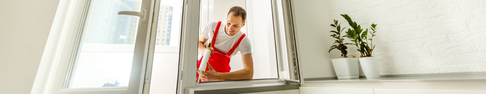 man sealing window