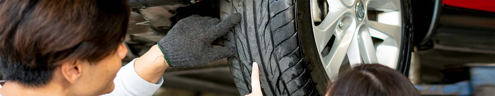 People inspecting tyre