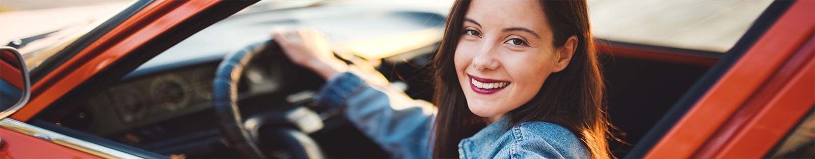 Woman in red car