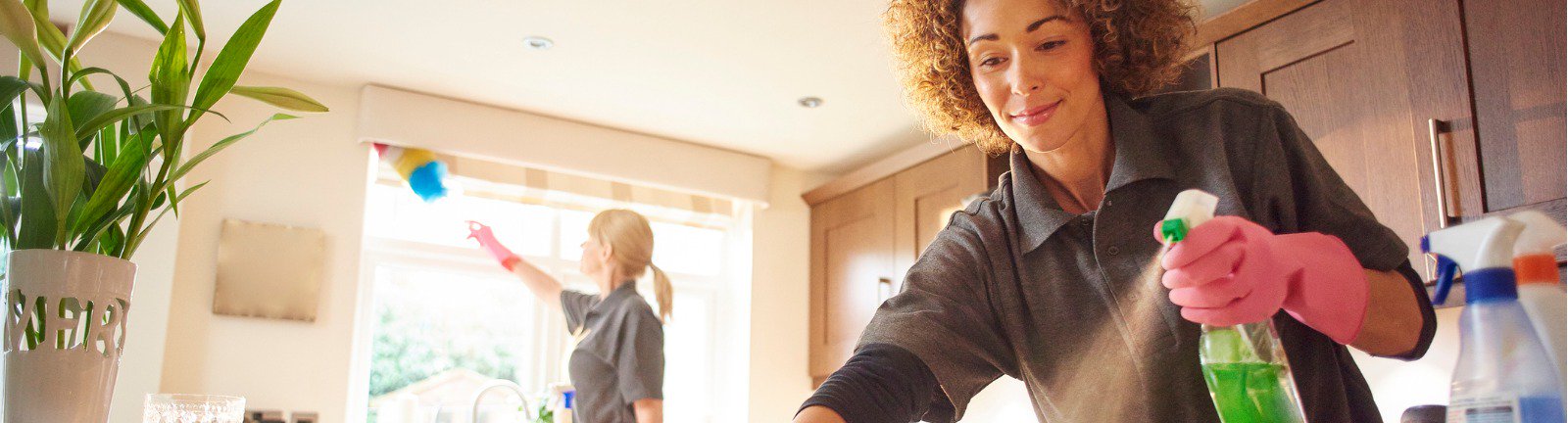 two women cleaning a kitchen