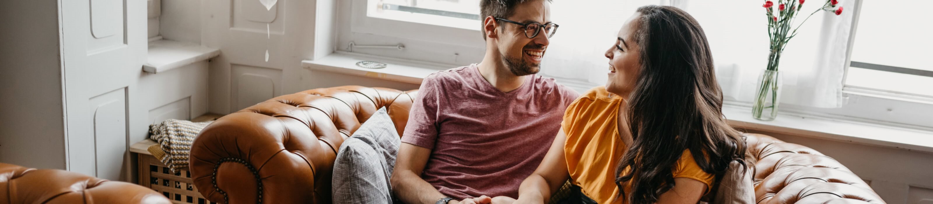 Smiling couple sitting on couch