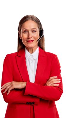 A professional woman dressed in a red blazer over a white shirt and wearing a headset is looking at the camera with her arms crossed