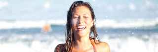 Woman walking out of the water at the beach