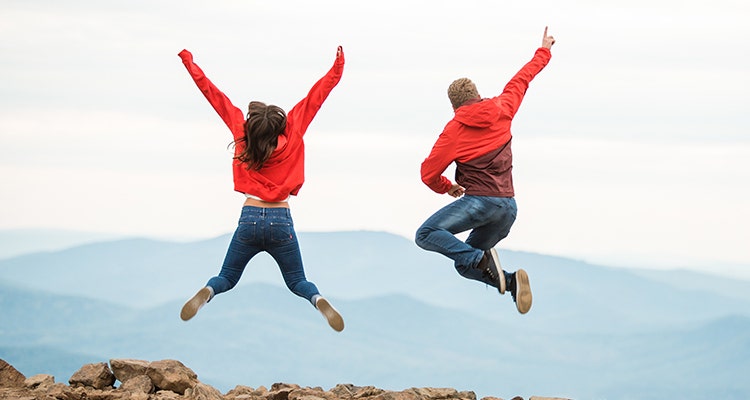 Two people jumping up in the air