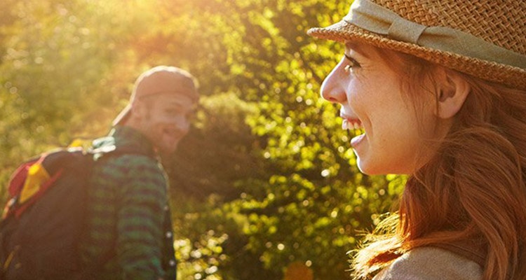 Woman and man walking outdoors on a sunny day