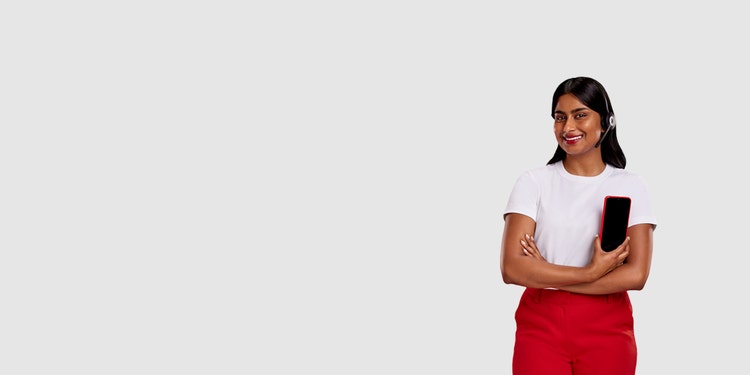 Woman in professional clothing holds a smartphone