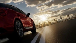 Red SUV driving on an open road at sunset approaching trees