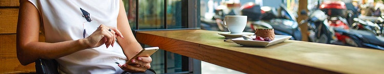 Woman on phone in cafe setting