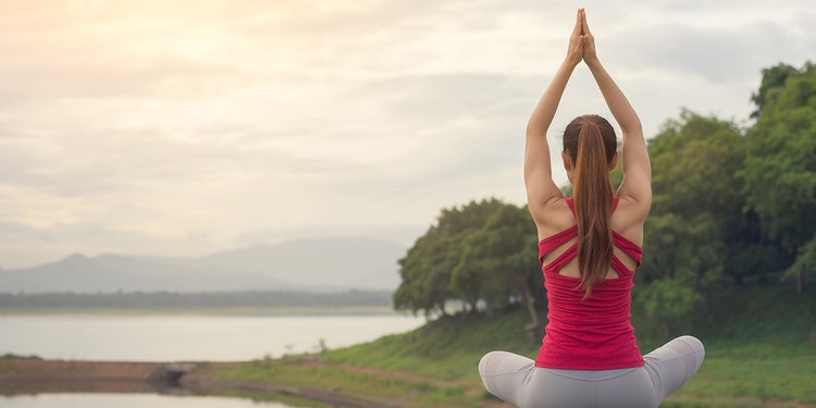 Woman doing a yoga pose outdoors